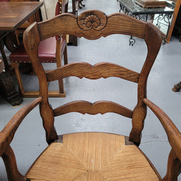 Pair of Louis XV Style Oak framed rush seated carver chairs. They have been sourced from France and in good original detailed condition.
