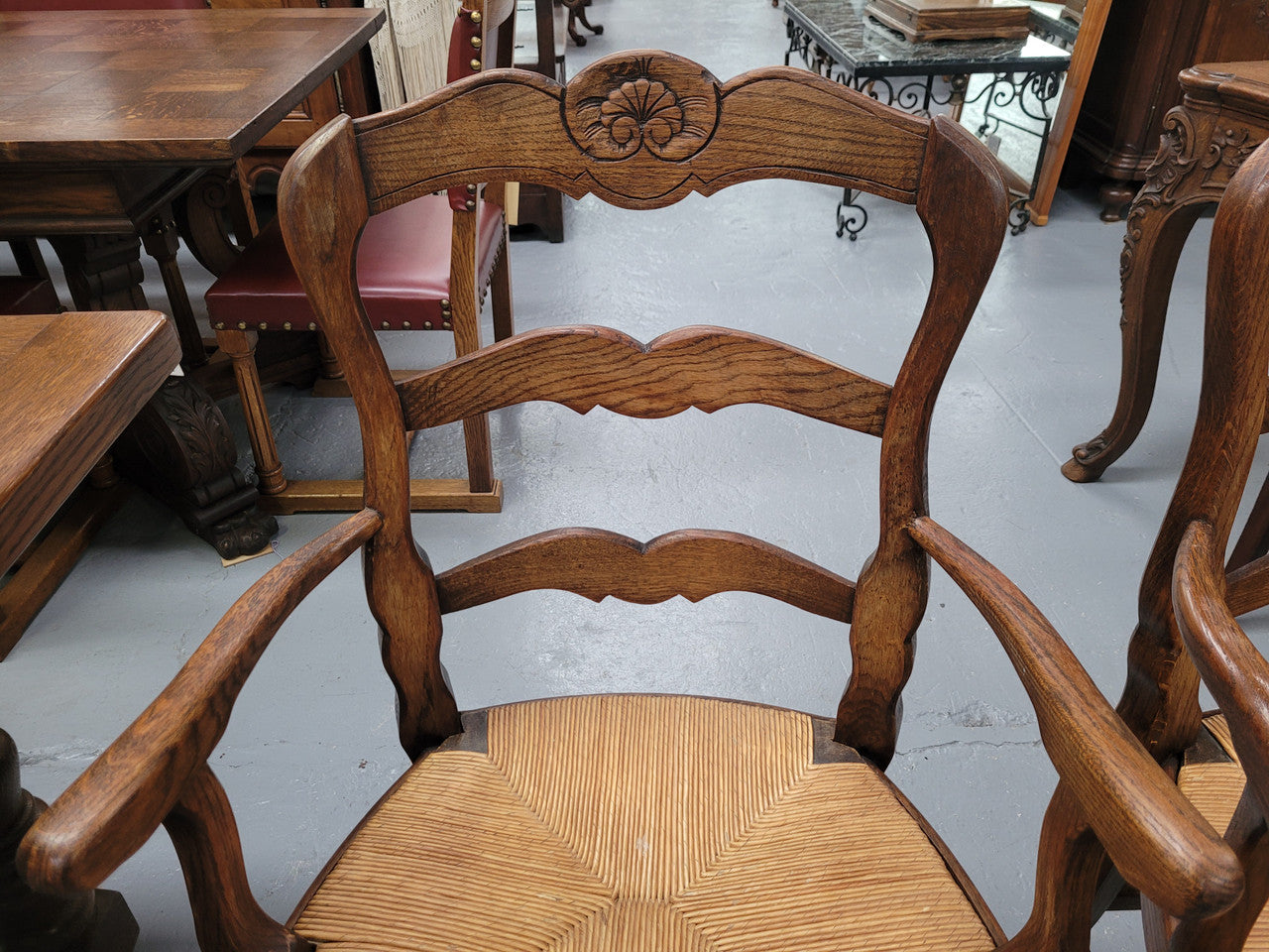 Pair of Louis XV Style Oak framed rush seated carver chairs. They have been sourced from France and in good original detailed condition.