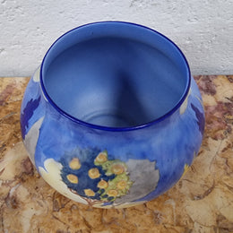 Carlton Ware vase globular shape with hand painted potted rose bush and hollyhocks in a blue/cream matt glaze.