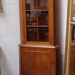 Practical Walnut corner cabinet with display and storage. Two shelf glass display on top and single shelf cupboard below. Sourced locally and in good original detailed condition.