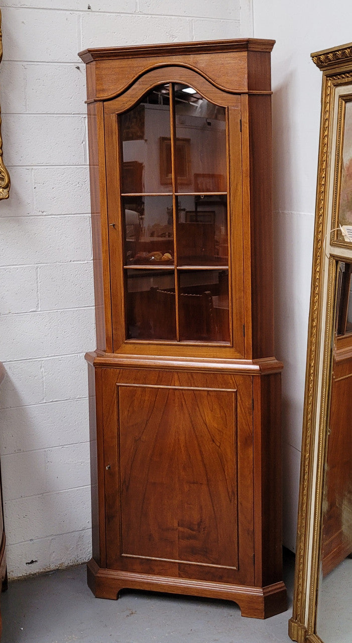 Practical Walnut corner cabinet with display and storage. Two shelf glass display on top and single shelf cupboard below. Sourced locally and in good original detailed condition.
