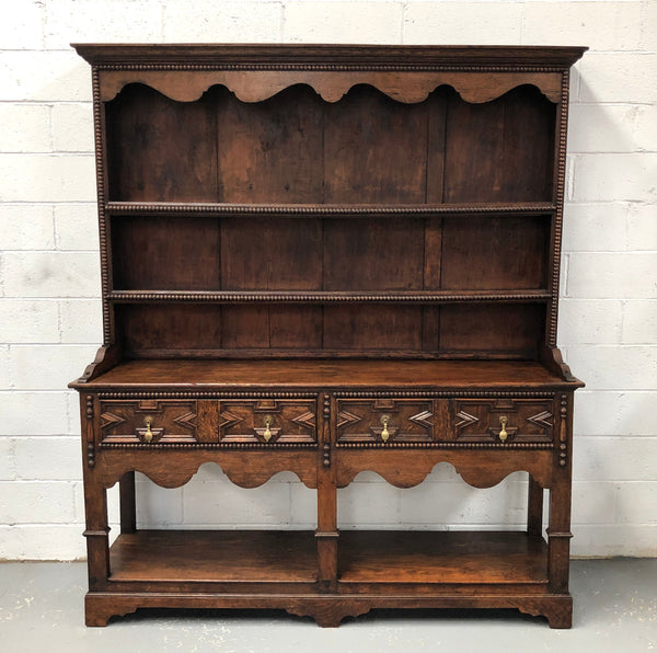 Fabulous Antique Tudor style Oak kitchen dresser with two drawers and two shelves. It is in good original detailed condition.