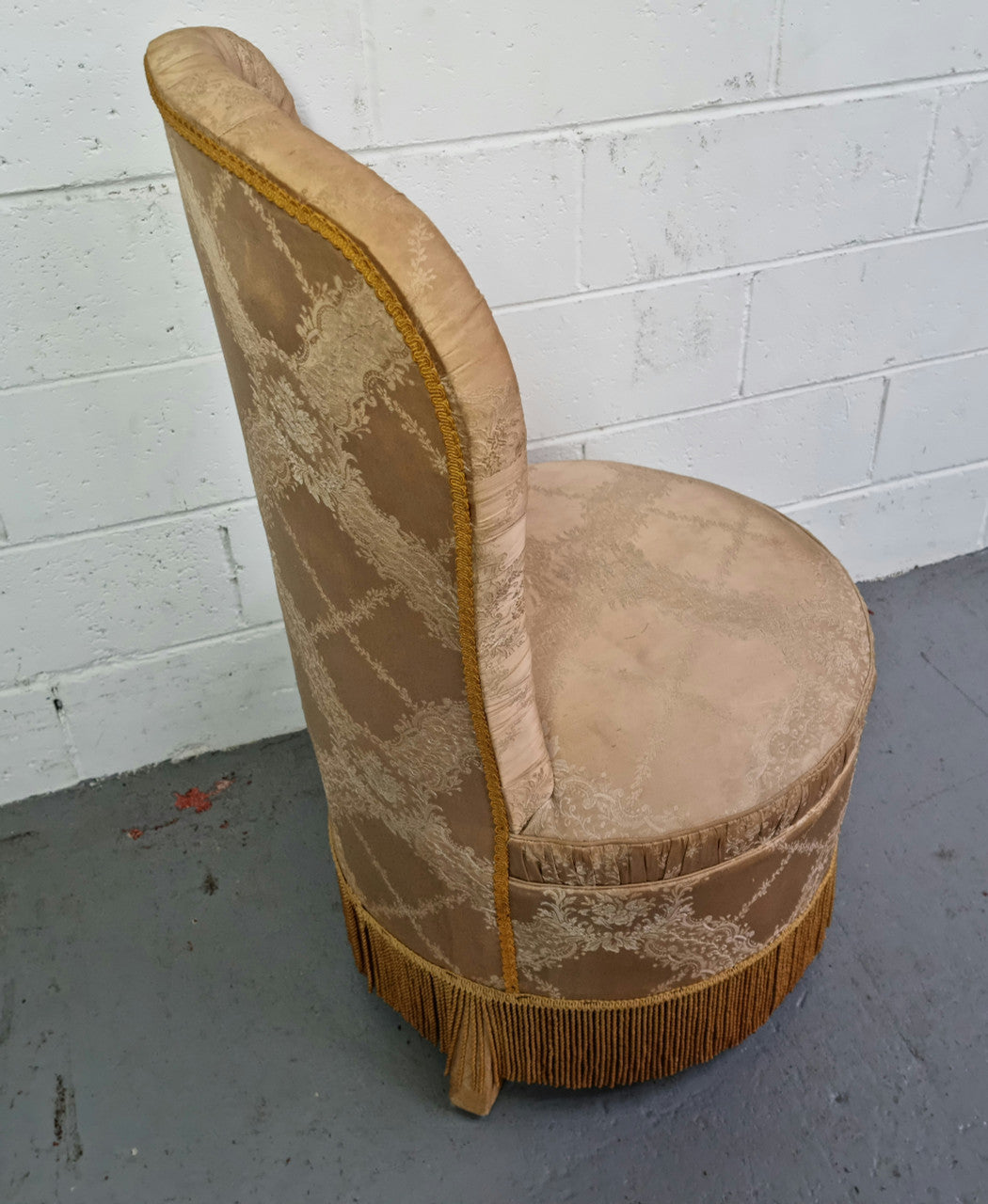 Vintage round upholstered button back bedroom chair. Beautiful gold upholstery in original condition with a gold fringe. original condition.