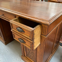 Lovely French Oak carved desk with four drawers and two cupboards. It is in good original detailed condition.