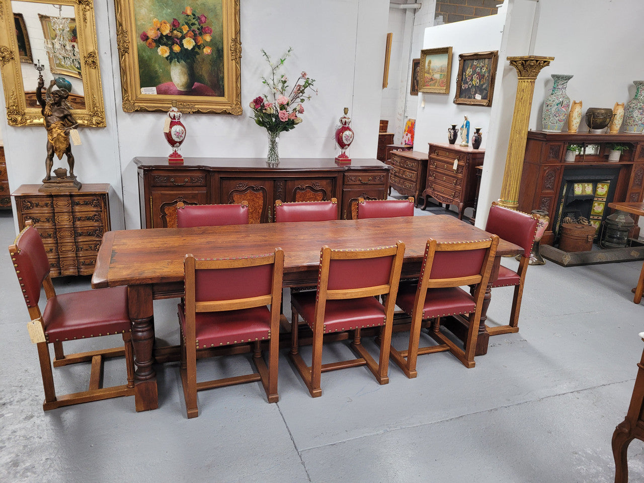 Charming solid rustic Oak stretcher base Farmhouse table. The table is circa 1950's and was custom made using reclaimed oak. It comfortable sits eight and could seat 10. It is in good original detailed condition.