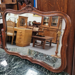 French Louis XV style carved Oak wall mirror. It is in good original detailed condition and has been sourced from France.