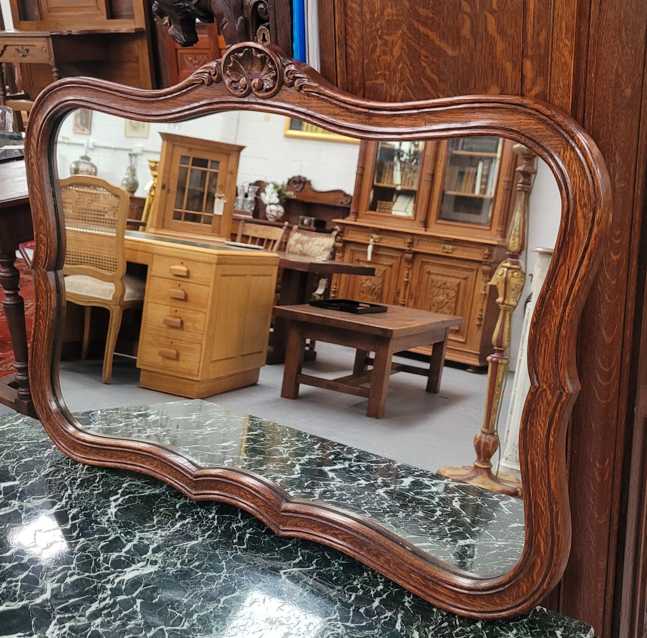 French Louis XV style carved Oak wall mirror. It is in good original detailed condition and has been sourced from France.