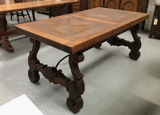 French Oak Renaissance style extension table with a lovely parquetry top and decorative carved and iron base in good original detailed condition.