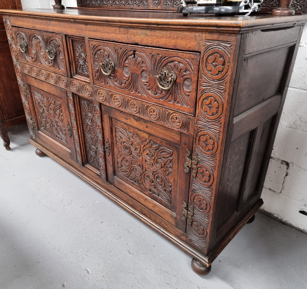 Impressively carved 18th Century English Oak kitchen dresser in 17th Century Jacobean style. It is in good original detailed condition and has been sourced from France.