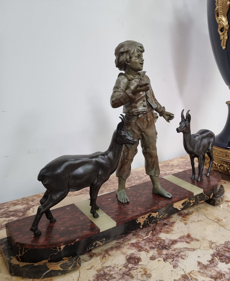 French Art Deco spelter and marble statue of a boy and two deers in good original condition.