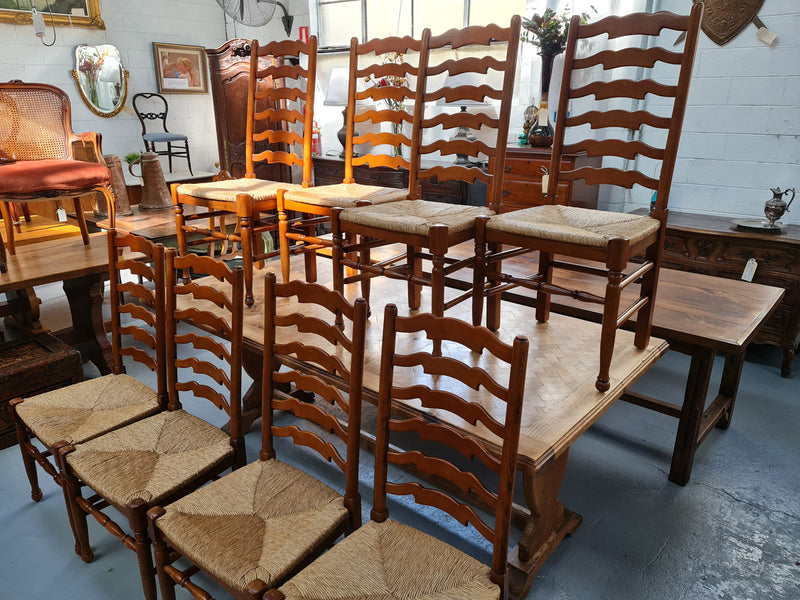 Charming set of eight Cherry Wood ladder back dining chairs. They are in good original detailed condition.