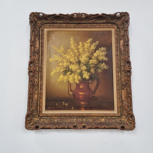 French floral still life painting oil on canvas of Wattle in a vase in a stunning decorative frame in good condition. Signed by artist and has been sourced from France.