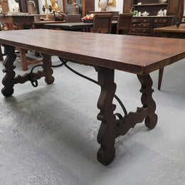Spanish style French Oak farmhouse table with ironwork underneath. It is in good original detailed condition and has been sourced from France.