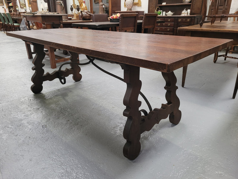 Spanish style French Oak farmhouse table with ironwork underneath. It is in good original detailed condition and has been sourced from France.