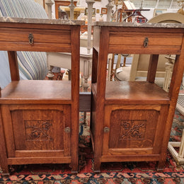 Charming pair of French Oak Arts and Crafts bedsides with shelf, cupboard with carving and marble top.  They have been sourced from France and are in good original detailed condition.