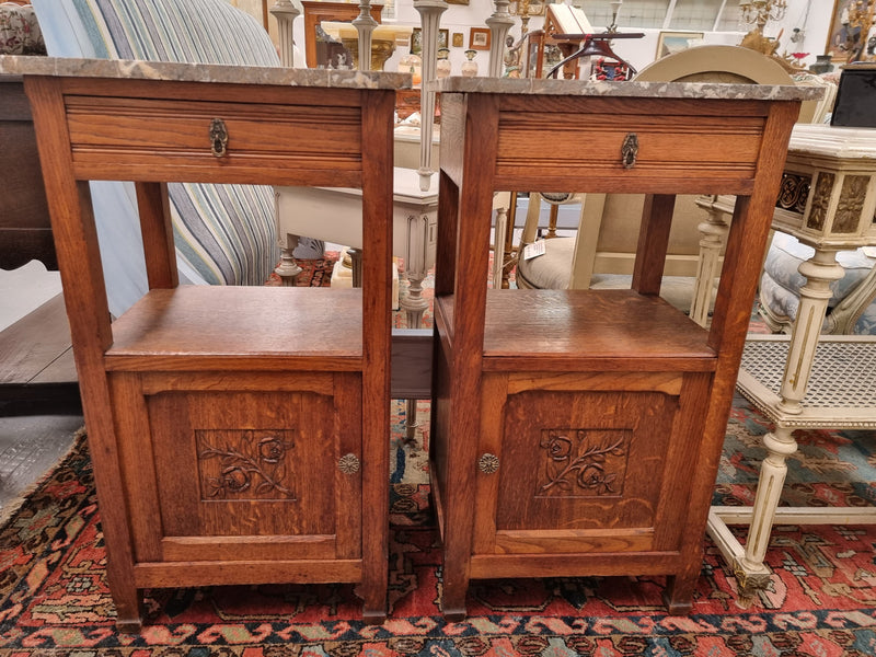 Charming pair of French Oak Arts and Crafts bedsides with shelf, cupboard with carving and marble top.  They have been sourced from France and are in good original detailed condition.