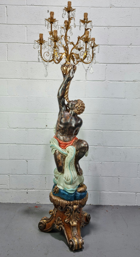 19th Century Italian Wooden Blackamoor lamp sourced in France. Made from carved wood painted & gilded. Amazing detail of a man playing a horn that then turns into a chandelier while riding a mythological sea serpent  It has been fully rewired to Australian standards.