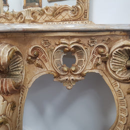 Beautifully carved Italian Rococo style painted console/hall table and mirror. An amazing coloured marble top showing sections of gold veins and is in good condition. Mantle mirror is retaining it's original mirror and showing ages spots.