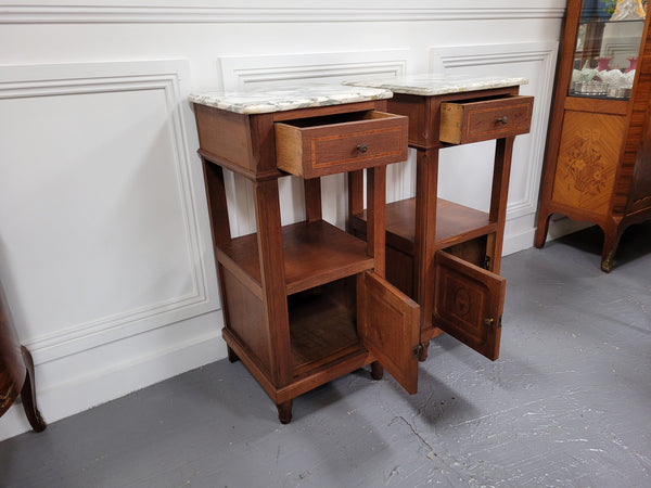 Pair of Antique French Oak Louis XVI style marble top bedside cabinets. They have decorative inlay and have been sourced from France. They are in good original detailed condition.