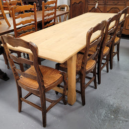 French raw Oak stretcher based refectory table. Features raw wood that could be used as is for a distressed look, or finished and waxed for a more refined look. Sourced from France and in good original condition.