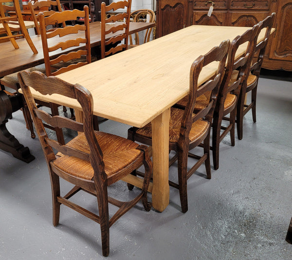 French raw Oak stretcher based refectory table. Features raw wood that could be used as is for a distressed look, or finished and waxed for a more refined look. Sourced from France and in good original condition.