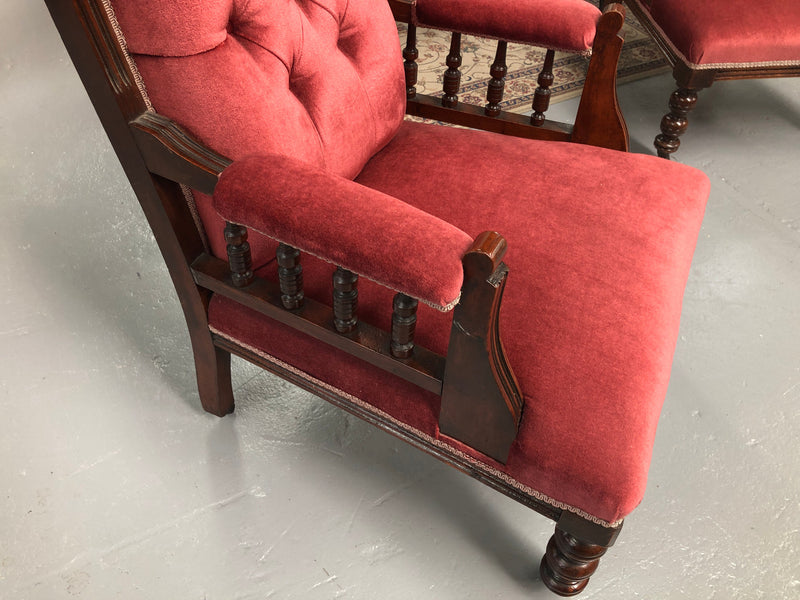 Beautiful pair of carved Edwardian arm chairs with lovely pink upholstery with button backs. In good condition.