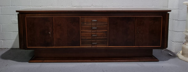 Amazing French Walnut Art deco four door buffet. The doors either side open to a fixed shelf and plenty of added storage with four drawers. In good original detailed condition.