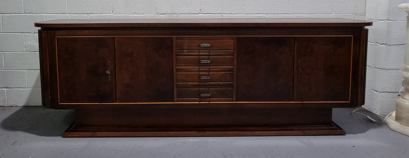 Amazing French Walnut Art deco four door buffet. The doors either side open to a fixed shelf and plenty of added storage with four drawers. In good original detailed condition.