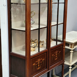 Edwardian Sheraton style display cabinet with hand-painted panels and a good fabric interior. In good original detailed condition.