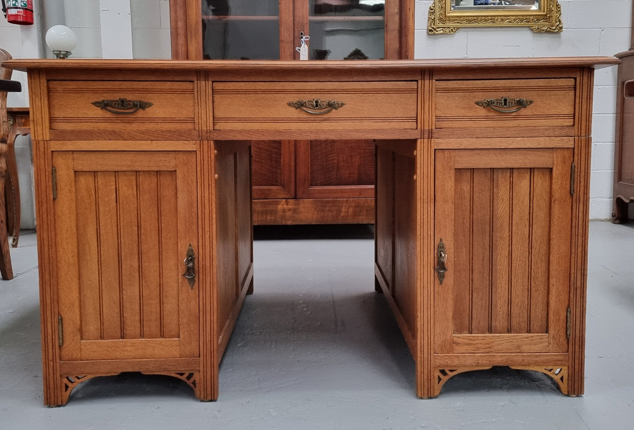 French Oak Art Deco full partners desk with leather top. Plenty of storage with both sides having three drawers at the top and two cupboards on both sides, one side has a filing section with three internal drawers and the other has a shelf on one side with three internal drawers as well. In good original detailed condition.