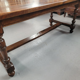 Rustic French Oak stretcher based farmhouse dining table that comfortably seats 6-8 people. It has been sourced from France and is in good original condition.