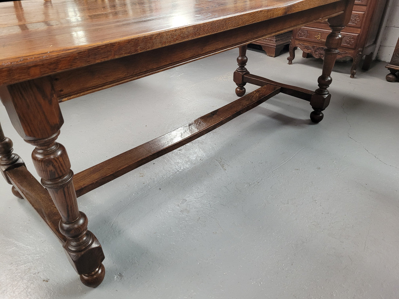 Rustic French Oak stretcher based farmhouse dining table that comfortably seats 6-8 people. It has been sourced from France and is in good original condition.