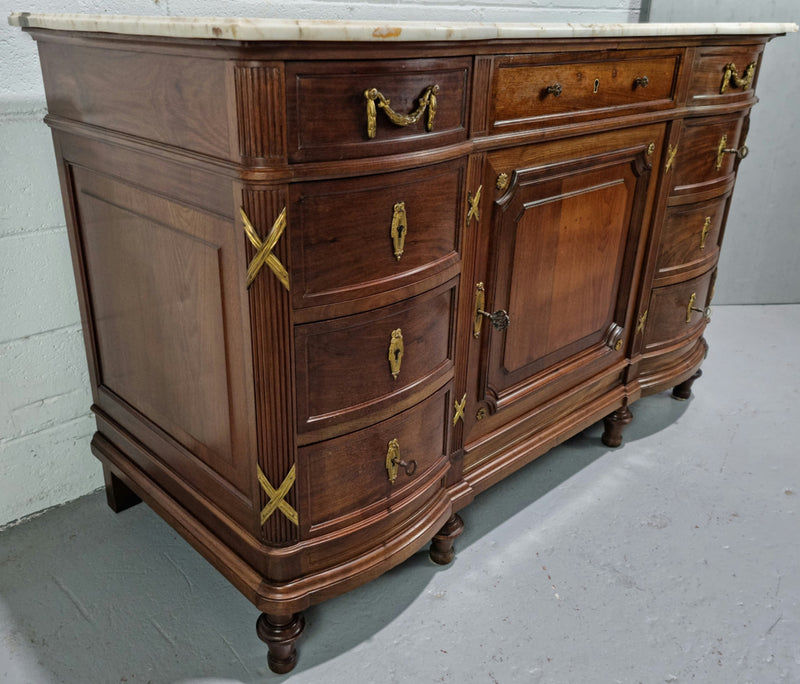 Fabulous French Walnut Louis XVI style cupboard, with a lovely marble top and nine drawers. There is also a cupboard and beautiful ormolu mounts. It is in good original detailed condition.