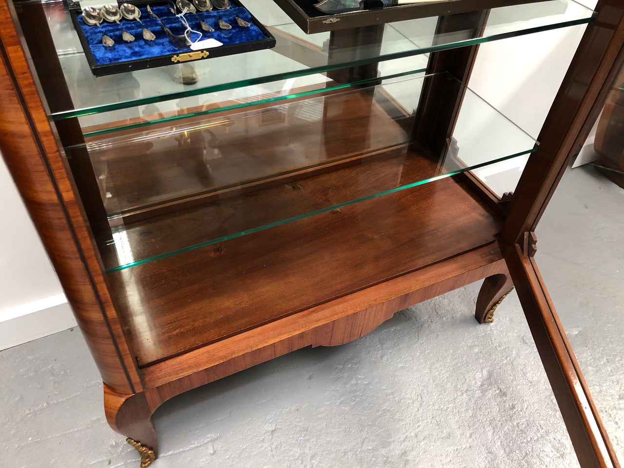 Beautiful French walnut and parquetry inlaid vitrine with lovely bevelled glass and a marble top. It comes with four glass shelves which are adjustable and it is in good original condition.