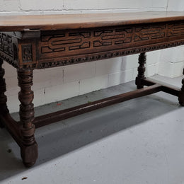 Rare and Charming 17th Century Spanish Walnut serving / side table. It has an incredible one piece walnut top with amazing character and colour. The base displays the original patina aswell as three drawers with carving and remnants of original locks. Superbly turned legs terminating on a stretcher base. Could be used as a large entrance console table, a side table or in a dining area as a serving table. In good original detailed condition especially considering its age.