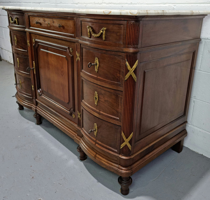 Fabulous French Walnut Louis XVI style cupboard, with a lovely marble top and nine drawers. There is also a cupboard and beautiful ormolu mounts. It is in good original detailed condition.