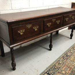 Early 19th Century English Oak dresser base with three large drawers. In very good original detailed condition.