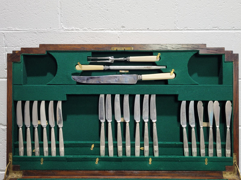English Oak beautifully fitted cutlery table with a lift up top and drawer. Contains extensive silver plate part cutlery service by Elkington. In good original condition.