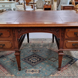 Substantial French Louis XVI style Oak partners desk. It has a beautiful leather top, two drawers on either side and decorative carvings throughout. Sourced from France and in good original detailed condition.