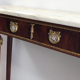 Narrow mahogany Louis XVI style console table with a marble top, ceramic inserts and gilt brass mounts.