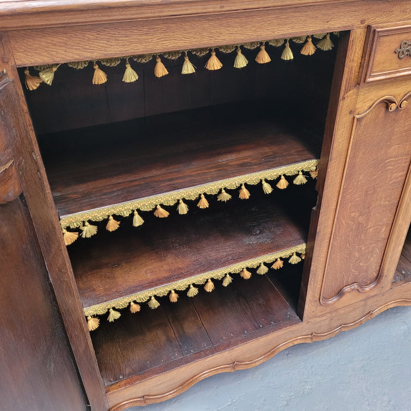 Amazing French Oak early 19th Century two door sideboard with one drawer and two fixed shelves. Sourced from France and in good original detailed condition.