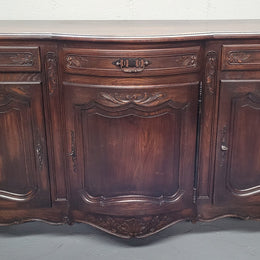 French dark oak three door and three drawer sideboard. Plenty of storage space and it is in good original detailed condition.