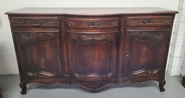French dark oak three door and three drawer sideboard. Plenty of storage space and it is in good original detailed condition.