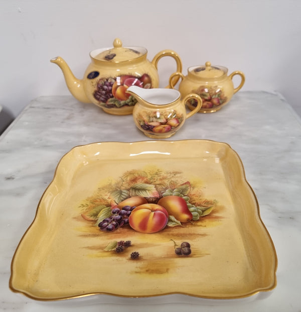 “Aynsley Orchard Gold” tea set on tray. Consisting of small teapot, lidded sugar and creamer. Please view photos as they help form part of the description.