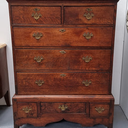 Early 19th Century English Oak chest on stand. It has been sourced in France and has plenty of storage space with eight drawers. In good original detailed condition.