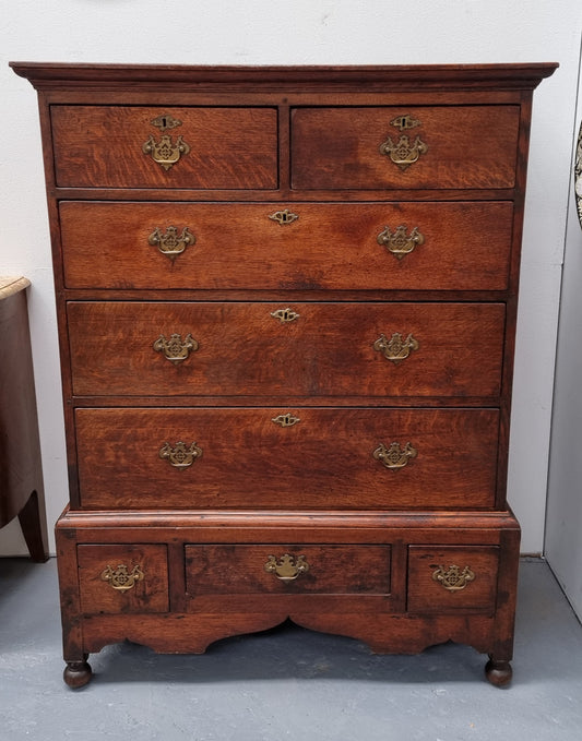 Early 19th Century English Oak chest on stand. It has been sourced in France and has plenty of storage space with eight drawers. In good original detailed condition.