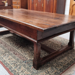 Impressive large size rustic French Oak coffee table with two drawers on a stretcher base. In good original detailed condition and sourced from France.