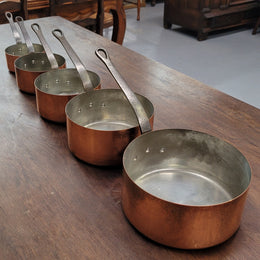 Set of five copper sauce pans with foundry stamp. They have been sourced from France and are in good original detailed condition.