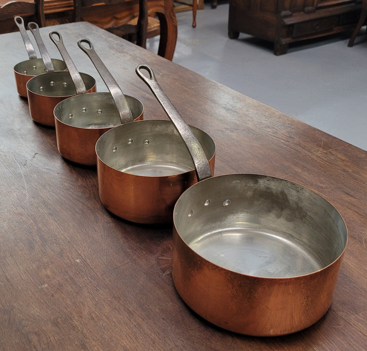 Set of five copper sauce pans with foundry stamp. They have been sourced from France and are in good original detailed condition.