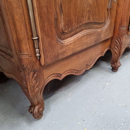 Parquetry top French oak Louis XV style sideboard with two draws and four cupboards. In good original detailed condition.